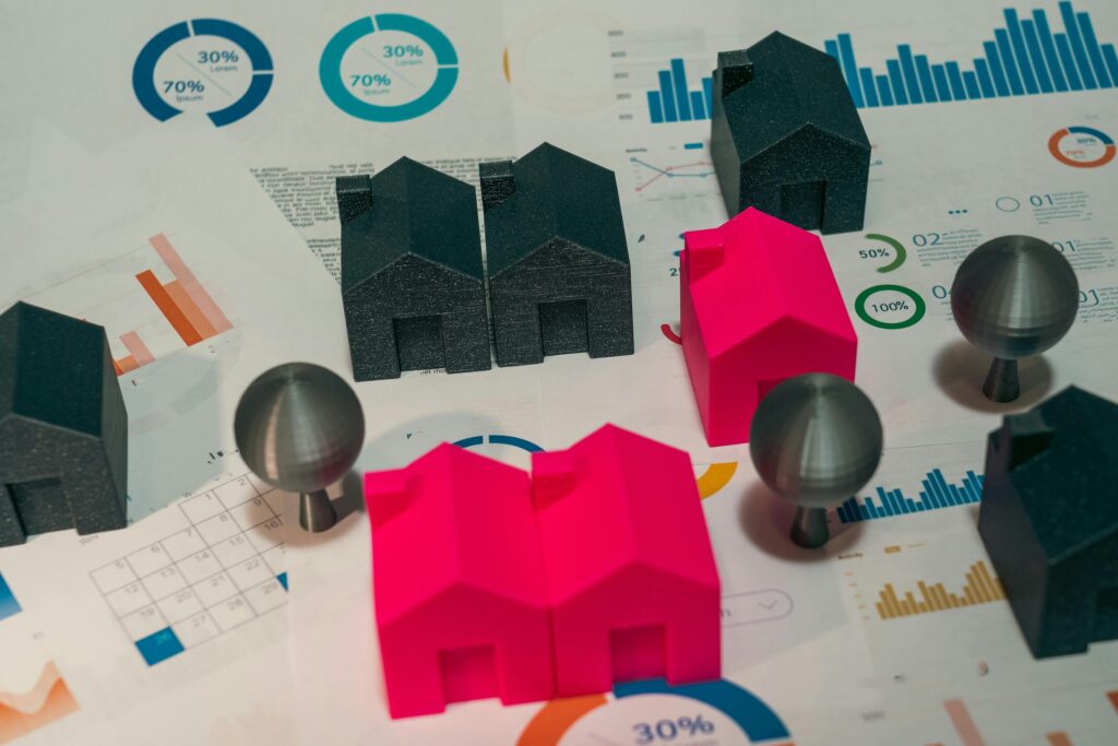 Home Value Estimates Abstract representation of real estate market analysis with model houses and charts.